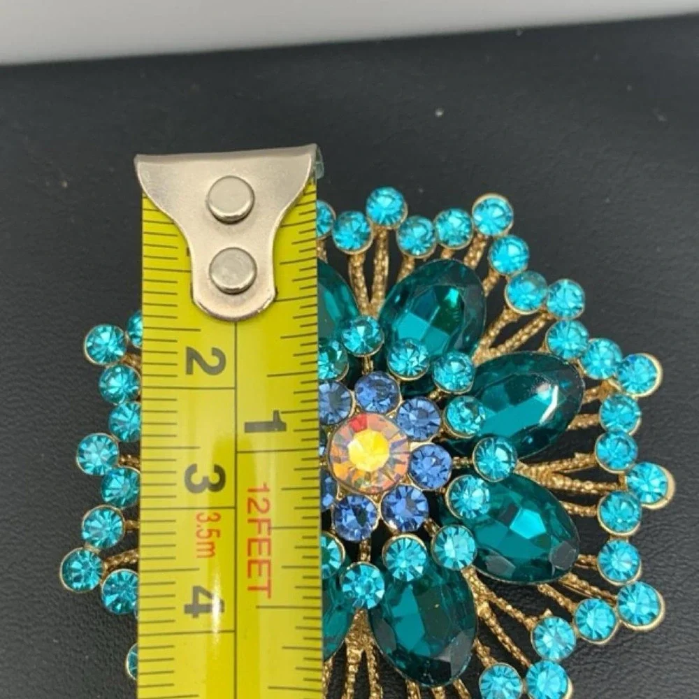 Gold tone and blue rhinestone brooch